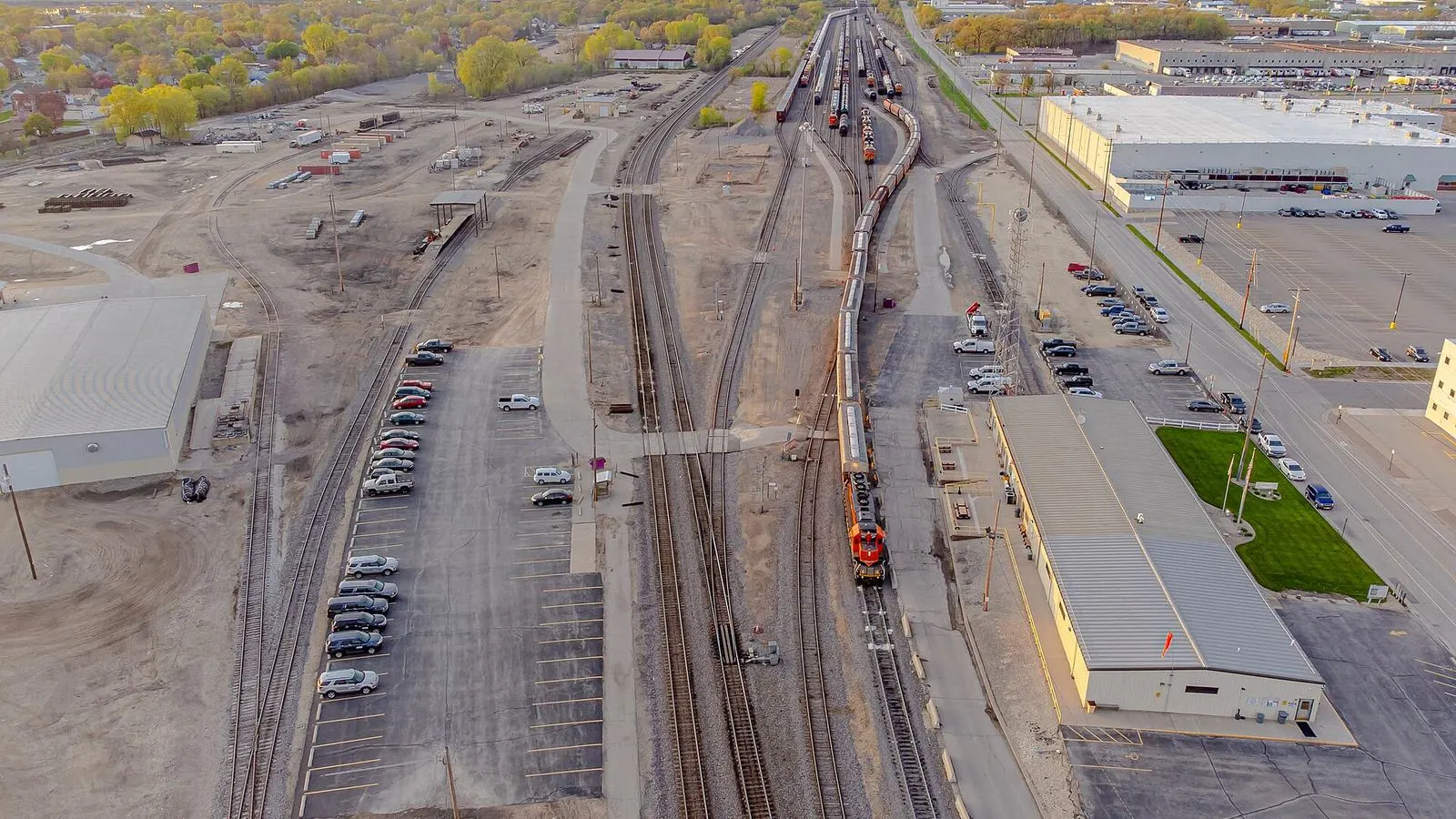 Aerial view of a rail yard and town at sunset