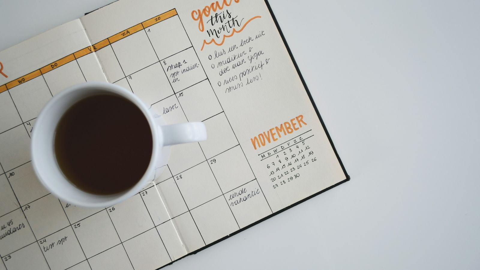 Monthly planner calendar with a cup of coffee