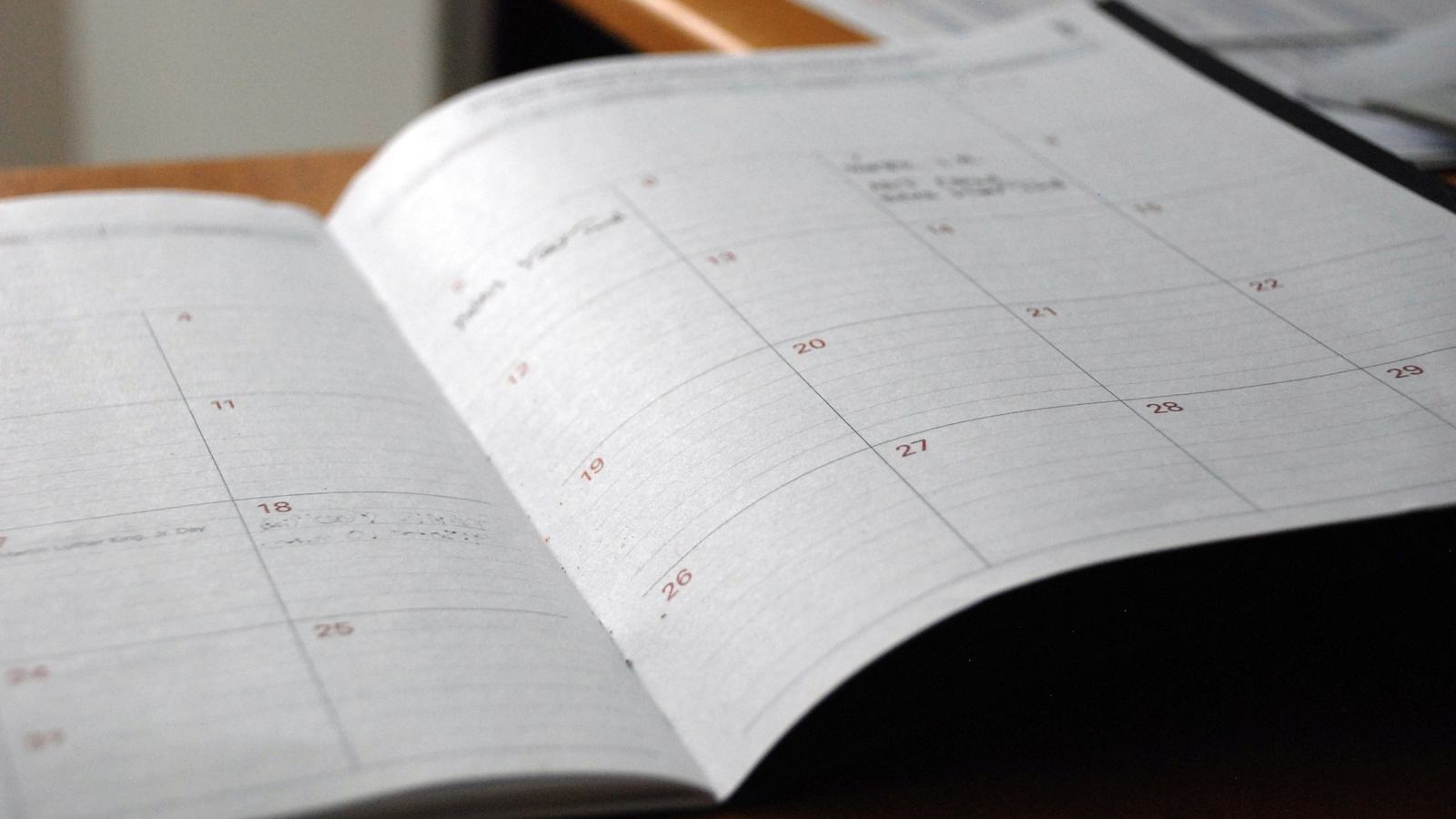 Open monthly planner calendar on a desk