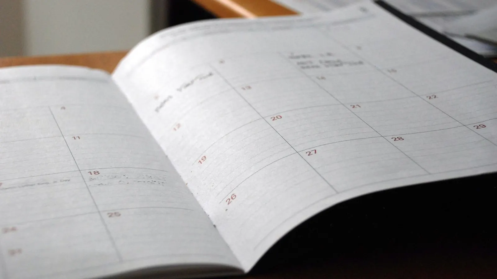 Open monthly planner calendar on a desk