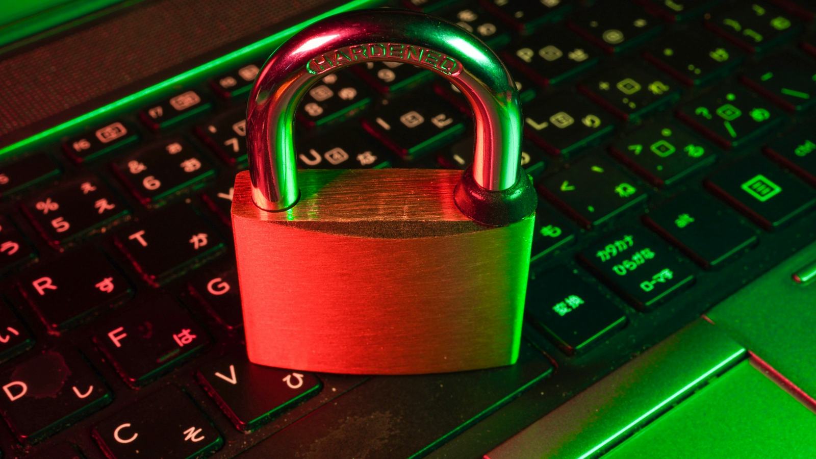 Padlock resting on an illuminated laptop keyboard