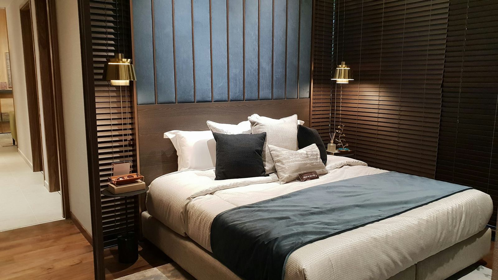 Quiet, dimly lit hotel room with a made bed ready for the next guest