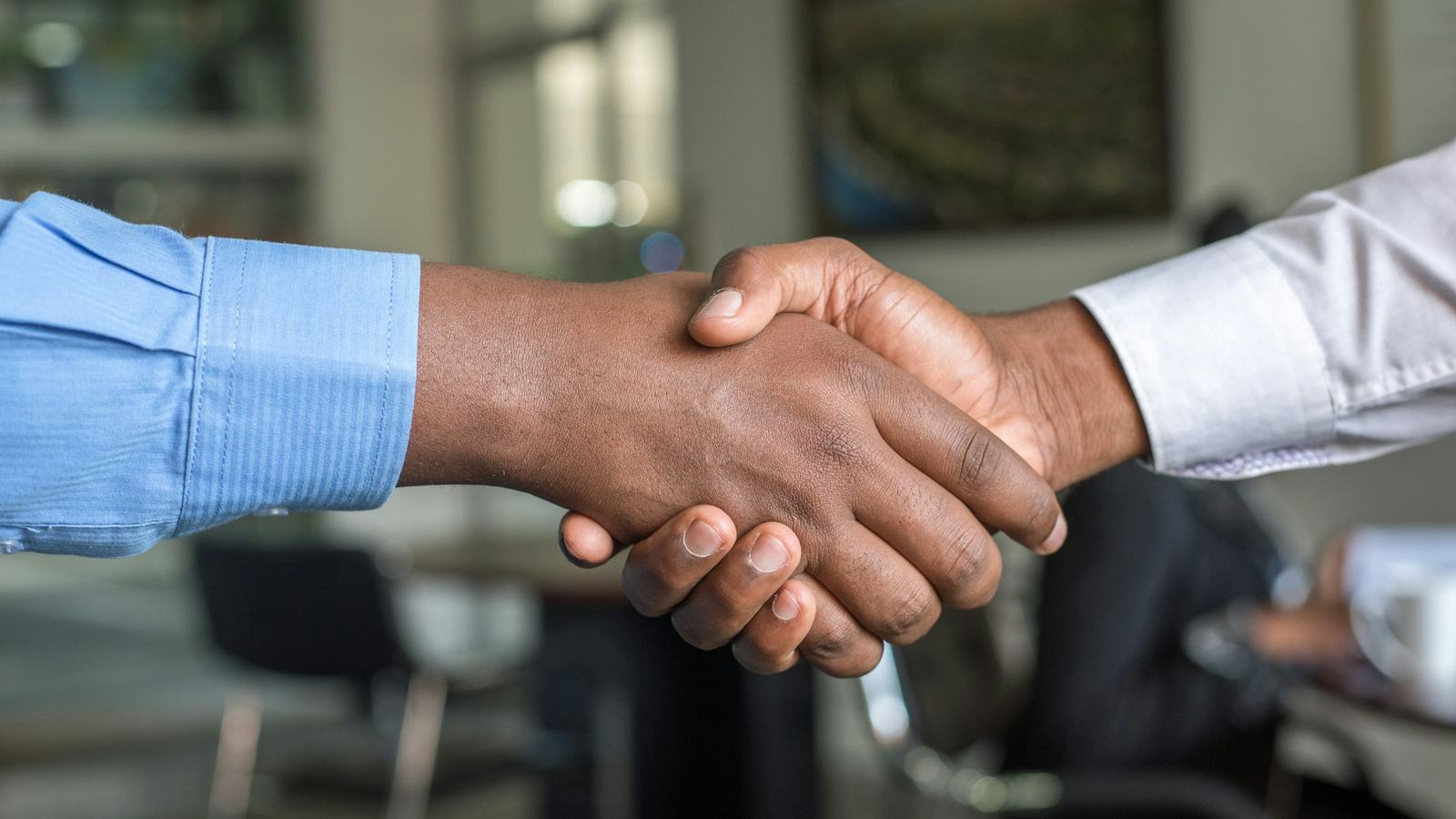 Handshake between two professionals in an office meeting