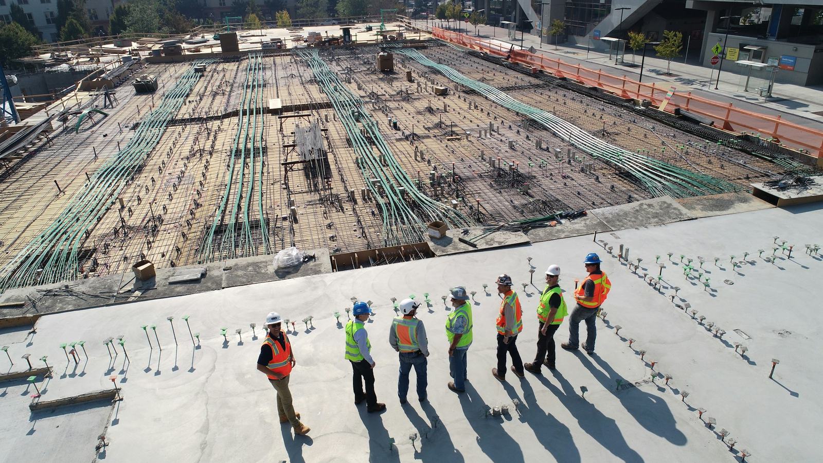 Construction crew in hard hats and safety vests on a job site